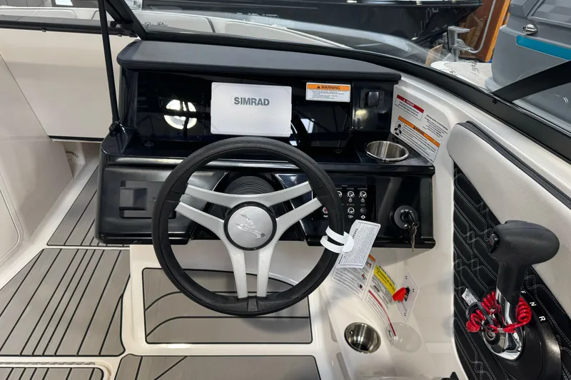 Slide: The Image of 2026 Sea Ray SPX 210 boat dashboard with steering wheel and control panel. - 17