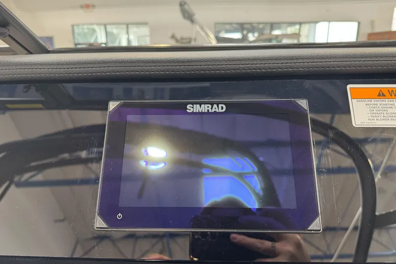 Slide: The Image of Simrad display on 2026 Sea Ray SPX 210 boat dashboard, reflecting interior lights. - 18