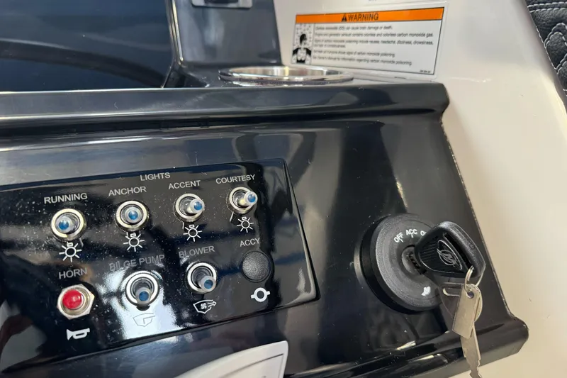 Slide: The Image of Control panel of 2026 Sea Ray SPX 210 boat with switches and ignition key. - 27