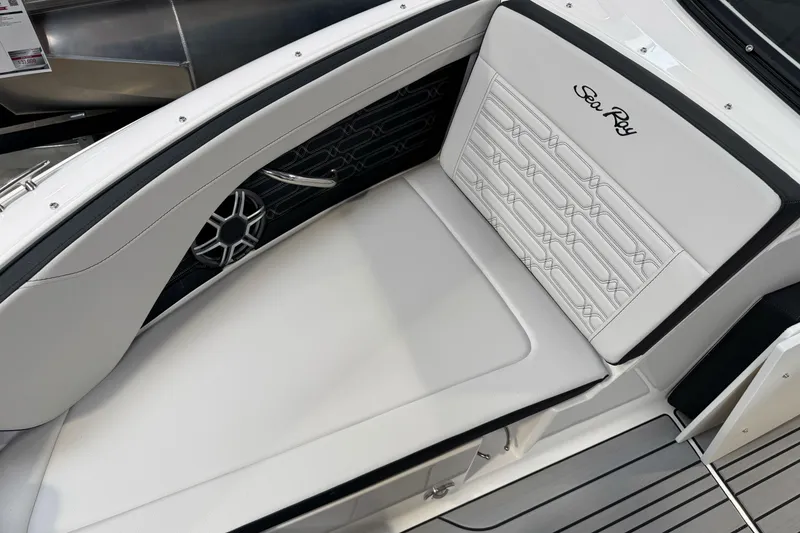 Slide: The Image of 2026 Sea Ray SPX 210 boat interior with white cushioned seating and sleek design. - 32