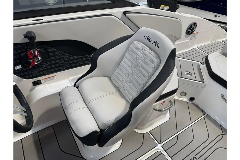 Slide: The Image of 2026 Sea Ray SPX 210 boat interior with sleek captain's seat and modern controls. - 34
