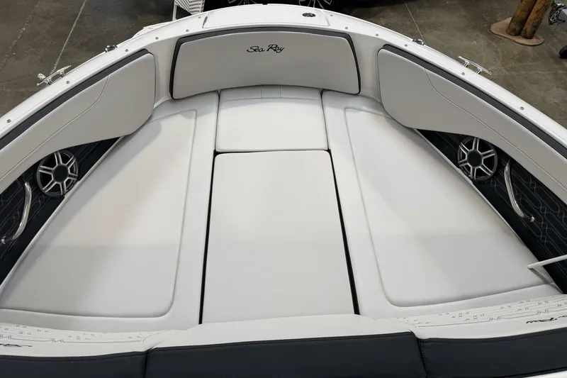 Slide: The Image of 2026 Sea Ray SPX 210 boat interior with white cushioned seating and built-in speakers. - 37