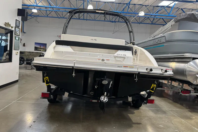 Slide: The Image of 2026 Sea Ray SPX 210 boat displayed in a showroom, rear view. - 39
