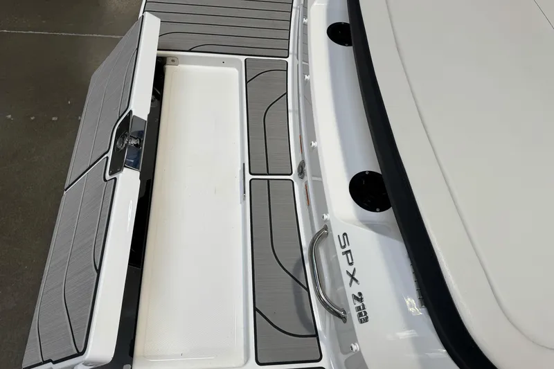 Slide: The Image of 2026 Sea Ray SPX 210 boat deck with storage compartment open. - 8