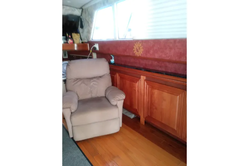 Slide: The Image of Interior of 1976 Viking 40 Convertible boat with recliner and wooden cabinetry. - 12