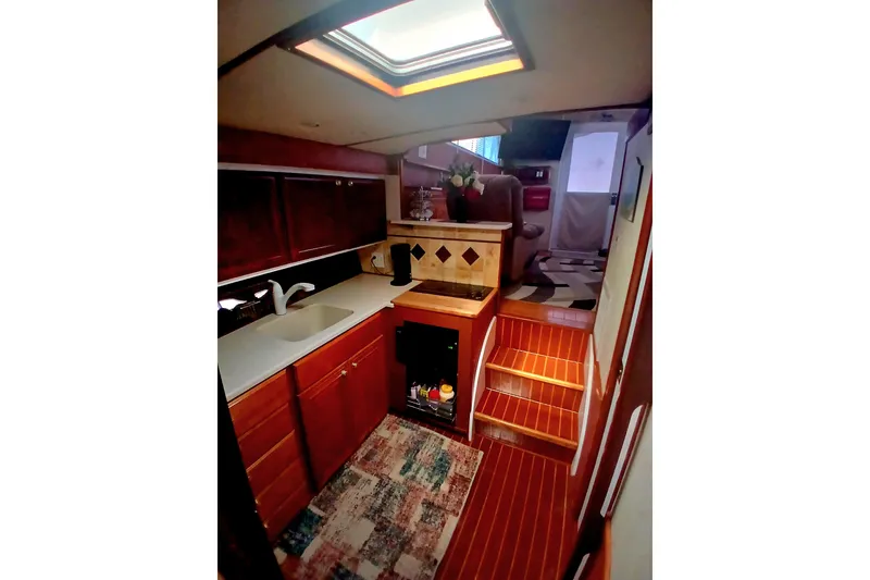 Slide: The Image of 1976 Viking 40 Convertible yacht interior with kitchen and wooden cabinetry. - 16