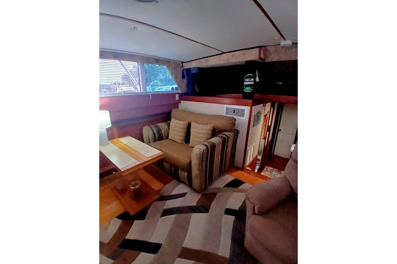 Slide: The Image of Interior of 1976 Viking 40 Convertible yacht, featuring cozy seating and modern decor. - 7