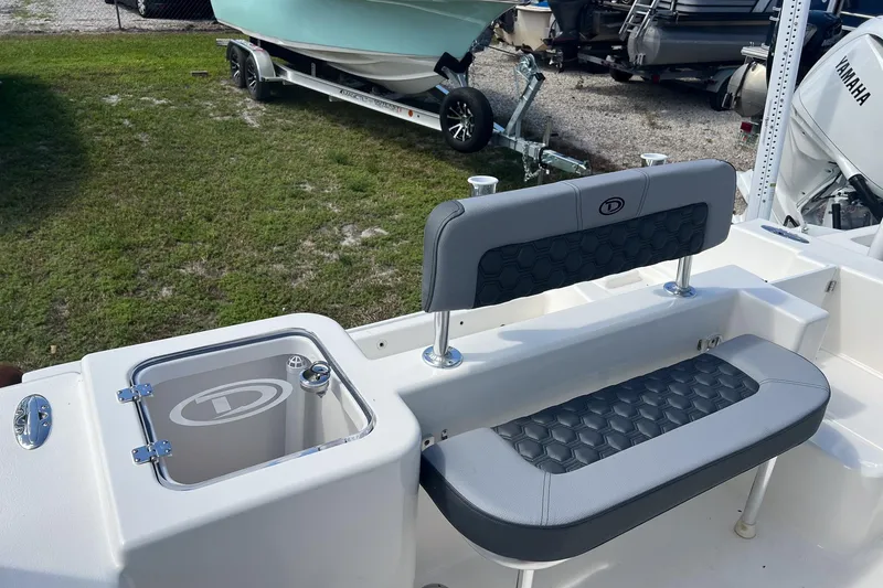 Slide: The Image of 2026 Defiance Catalina 210 boat interior with seating and storage compartment. - 11