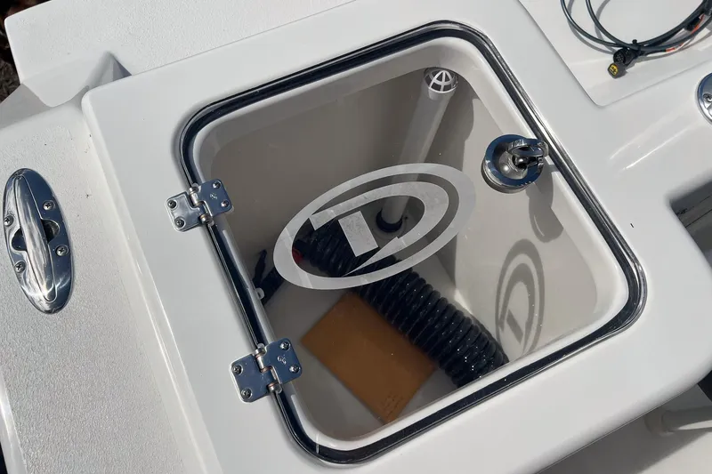 Slide: The Image of Livewell compartment on 2026 Defiance Catalina 210 boat, featuring a transparent lid and chrome fittings. - 13