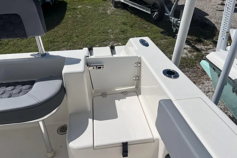 Slide: The Image of 2026 Defiance Catalina 210 boat interior with seating and storage compartment. - 15
