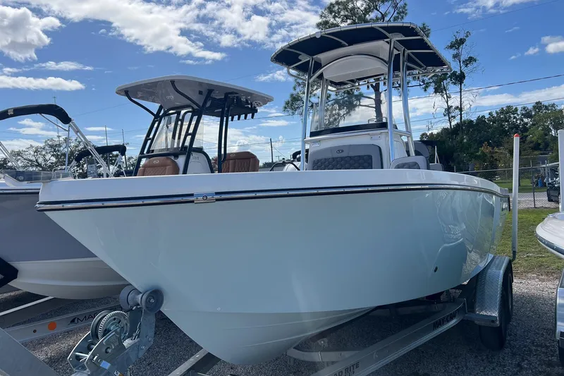 Slide: The Image of 2026 Defiance Catalina 210 boat on trailer under blue sky. - 2