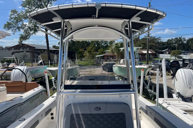 Slide: The Image of 2026 Defiance Catalina 210 boat with T-top, displayed in a marina setting. - 23