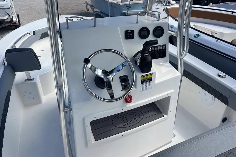 Slide: The Image of 2026 Defiance Catalina 210 boat cockpit with steering wheel and control panel. - 6