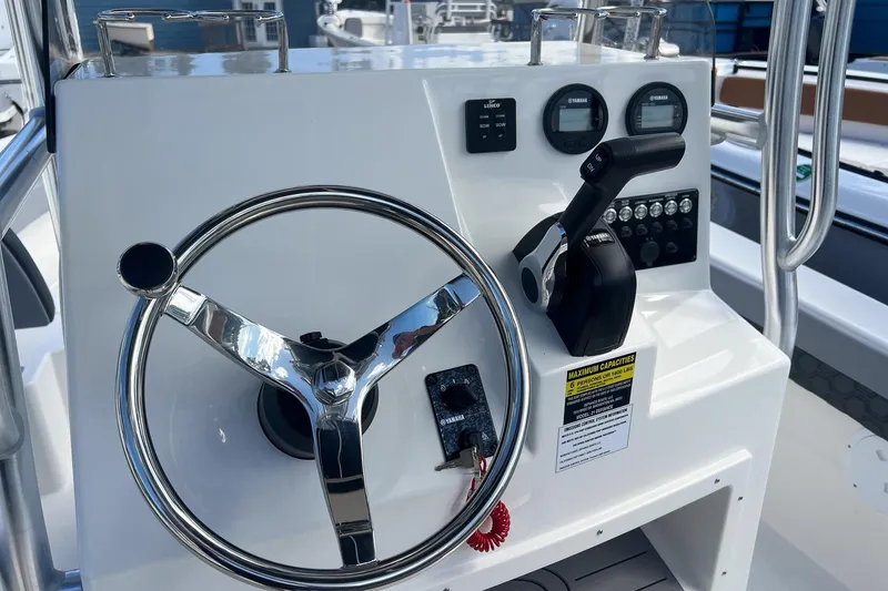 Slide: The Image of 2026 Defiance Catalina 210 boat console with steering wheel and controls. - 7