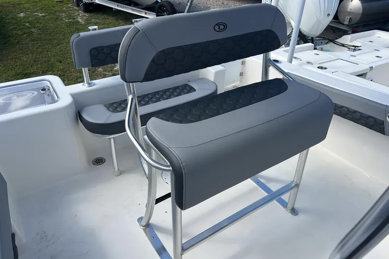 Slide: The Image of 2026 Defiance Catalina 210 boat interior with gray seating and stainless steel frame. - 9
