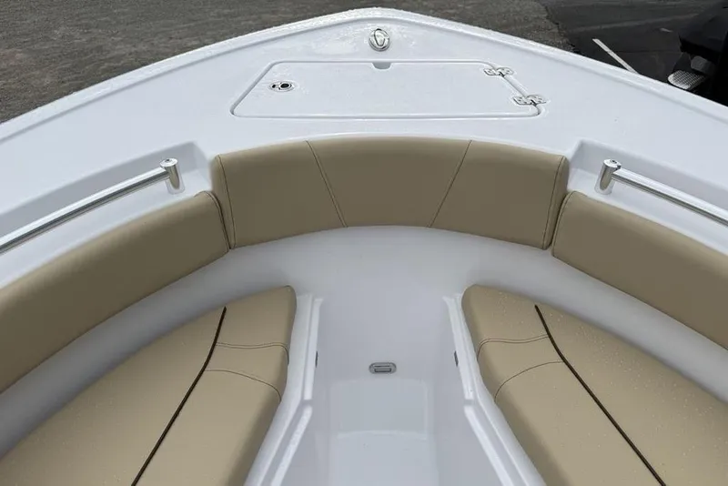 Slide: The Image of 2026 Sportsman Open 212 Center Console boat with beige seating and storage compartment. - 10