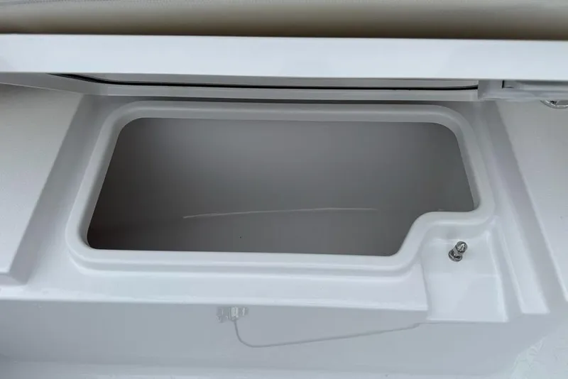 Slide: The Image of 2026 Sportsman Open 212 Center Console storage compartment, open and empty. - 11