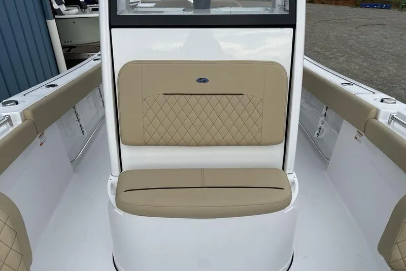 Slide: The Image of 2026 Sportsman Open 212 Center Console boat interior with tan cushioned seating. - 12