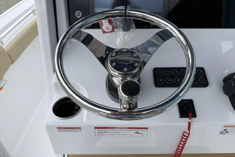 Slide: The Image of Steering wheel of 2026 Sportsman Open 212 Center Console boat, featuring modern controls. - 13