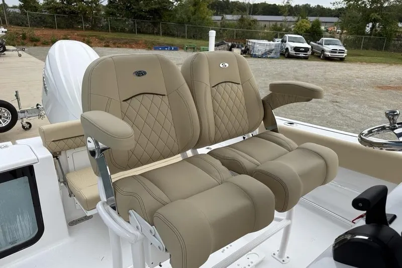 Slide: The Image of 2026 Sportsman Open 212 Center Console boat with luxurious beige seating. - 14