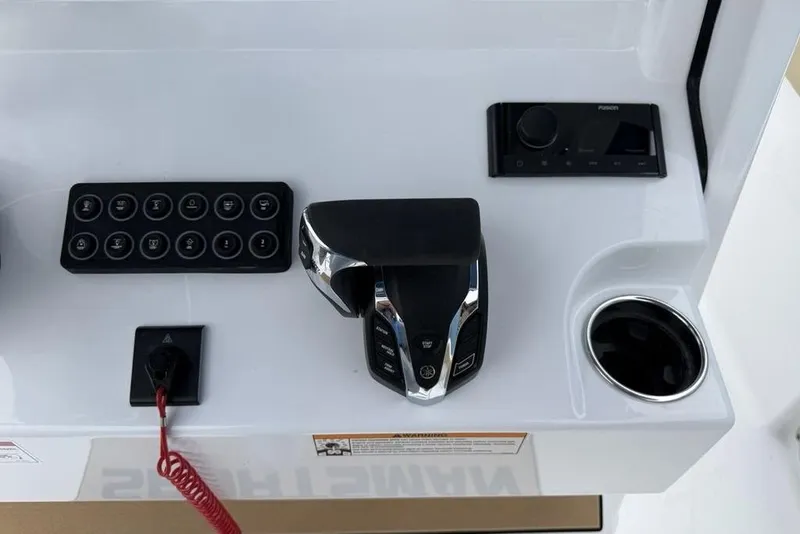 Slide: The Image of 2026 Sportsman Open 212 Center Console dashboard with controls and cup holder. - 17