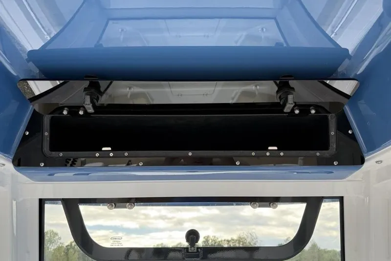 Slide: The Image of 2026 Sportsman Open 212 Center Console storage compartment, open view, blue and white design. - 21