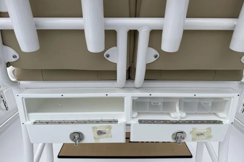 Slide: The Image of 2026 Sportsman Open 212 Center Console storage compartments and rod holders. - 28