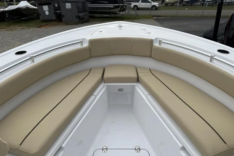 Slide: The Image of 2026 Sportsman Open 212 Center Console boat with beige cushioned seating. - 7
