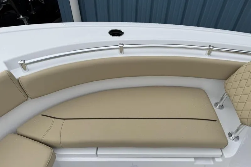 Slide: The Image of 2026 Sportsman Open 212 Center Console boat with beige cushioned seating. - 8