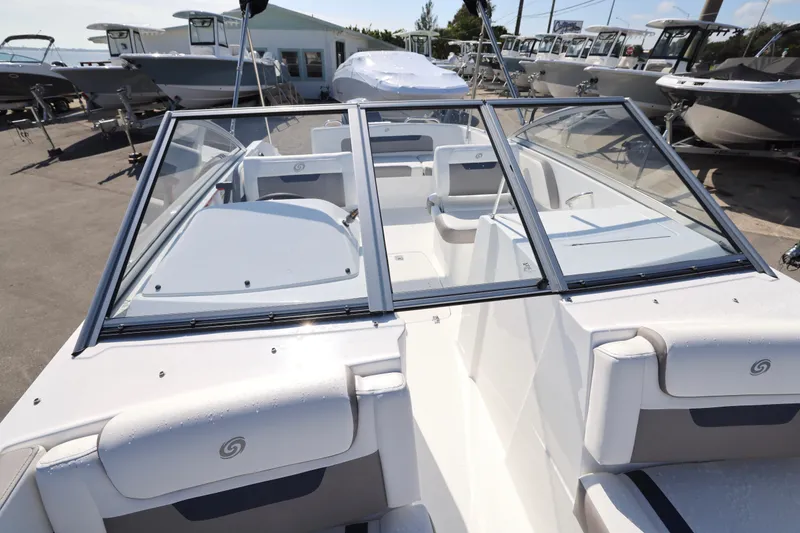 Slide: The Image of 2026 Hurricane SunDeck 235 OB boat interior with white and gray seating arrangement. - 12