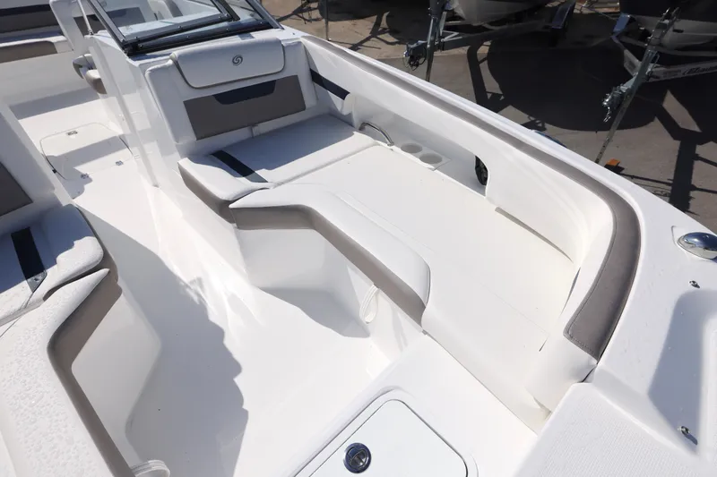 Slide: The Image of 2026 Hurricane SunDeck 235 OB boat interior with seating and windshield, displayed outdoors. - 13