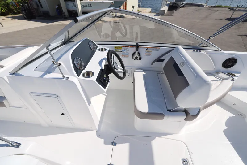 Slide: The Image of 2026 Hurricane SunDeck 235 OB boat interior with white seating and cup holders. - 14