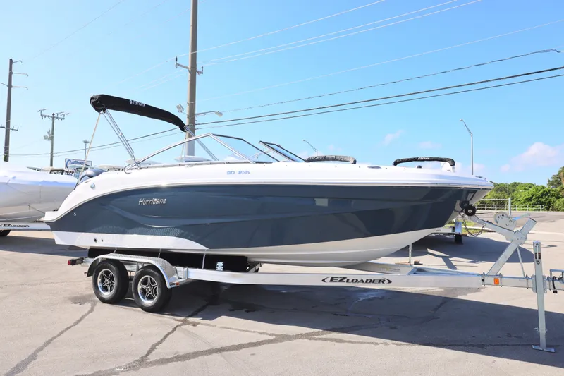 Slide: The Image of 2026 Hurricane SunDeck 235 OB boat with Yamaha outboard motor on trailer. - 19