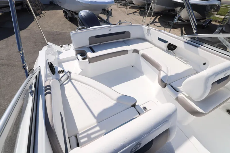 Slide: The Image of 2026 Hurricane SunDeck 235 OB boat interior with white seating and open deck layout. - 2
