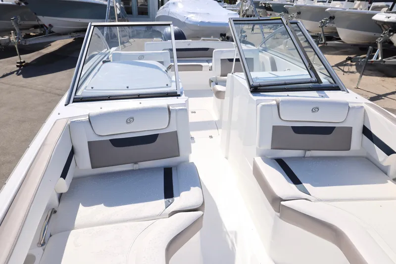 Slide: The Image of 2026 Hurricane SunDeck 235 OB boat interior with steering wheel and seating. - 4