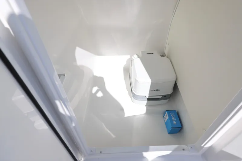 Slide: The Image of 2026 Hurricane SunDeck 235 OB boat interior with seating and windshield, displayed outdoors. - 5