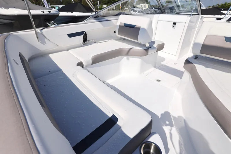 Slide: The Image of 2026 Hurricane SunDeck 235 OB boat interior with portable toilet and storage space. - 6