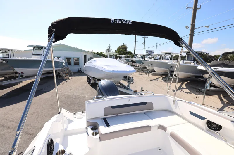 Slide: The Image of 2026 Hurricane SunDeck 235 OB boat interior with spacious seating and modern design. - 9