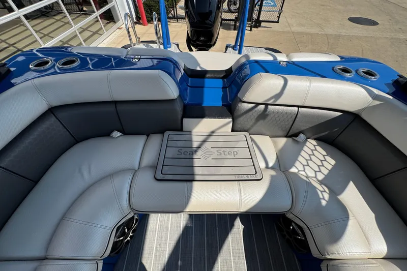 Slide: The Image of 2022 South Bay 25 Sport CR9-DC boat interior with cushioned seating and cup holders. - 10