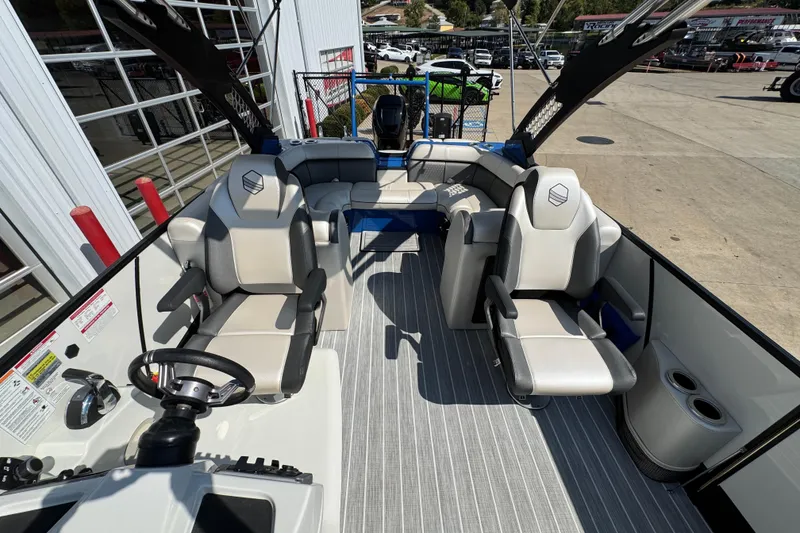 Slide: The Image of 2022 South Bay 25 Sport CR9-DC boat interior with modern seating and steering wheel. - 13