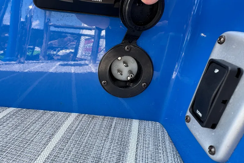 Slide: The Image of Close-up of a 2022 South Bay 25 Sport CR9-DC boat's electrical socket and switch. - 29