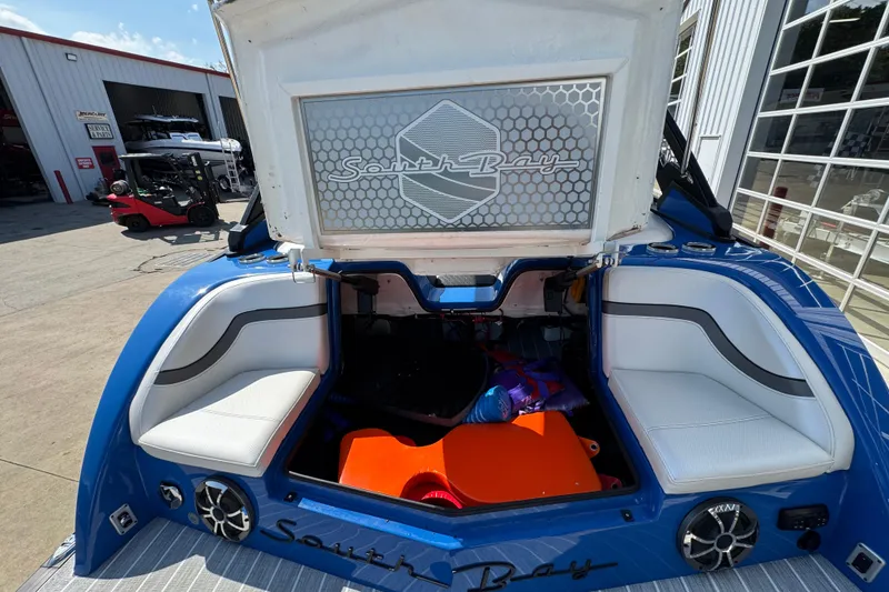 Slide: The Image of 2022 South Bay 25 Sport CR9-DC boat interior with open storage compartment. - 8