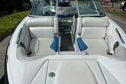Slide: The Image of 2012 MasterCraft X25 boat with white and blue interior seating. - 12