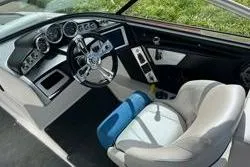 Slide: The Image of 2012 MasterCraft X25 boat interior with steering wheel and dashboard controls. - 8
