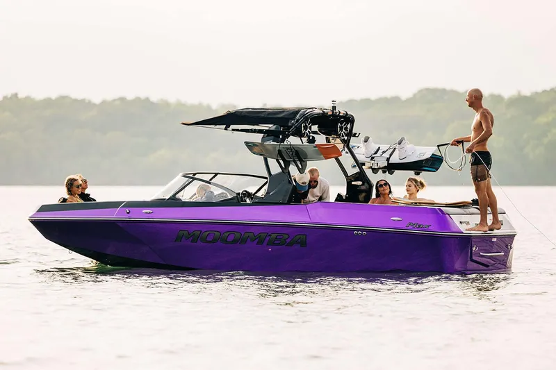 Slide: The Image of Manufacturer Provided Image: 2026 Moomba Max boat on lake with people enjoying water activities. - 13