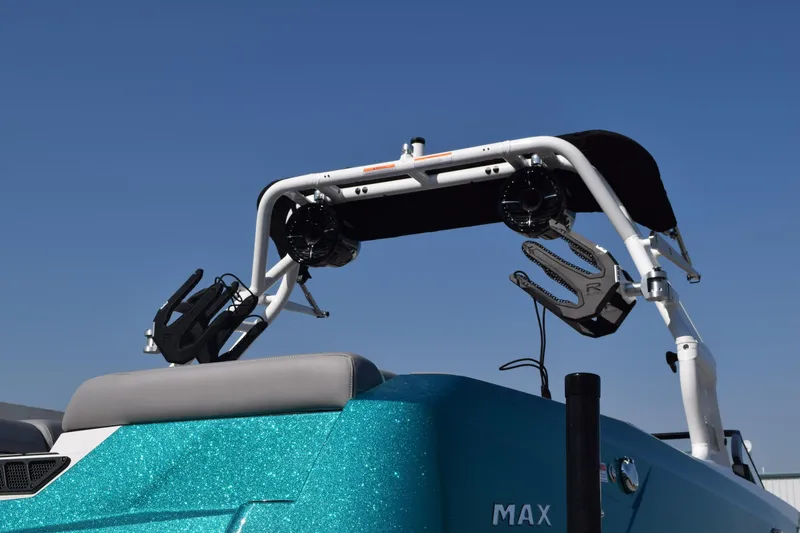 Slide: The Image of 2026 Moomba Max boat with wakeboard tower against clear blue sky. - 3