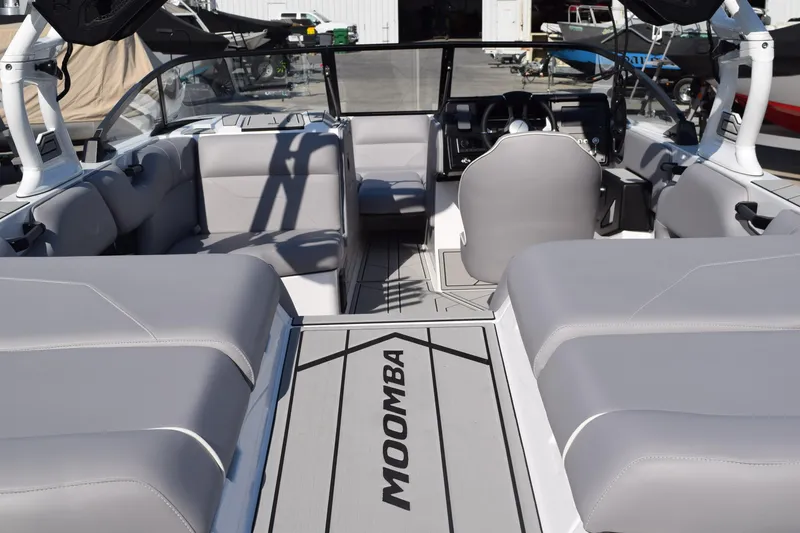 Slide: The Image of 2026 Moomba Max boat interior with gray seating and modern dashboard design. - 4