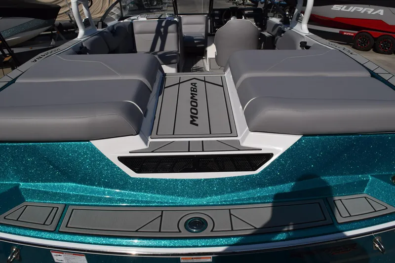 Slide: The Image of 2026 Moomba Max boat with gray seating and teal glitter finish. - 5