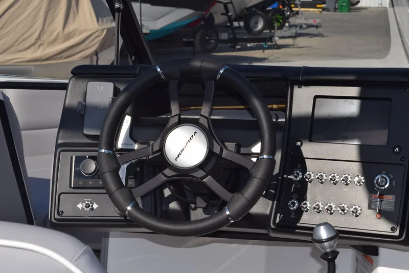 Slide: The Image of 2026 Moomba Max boat dashboard with steering wheel and control panel. - 9