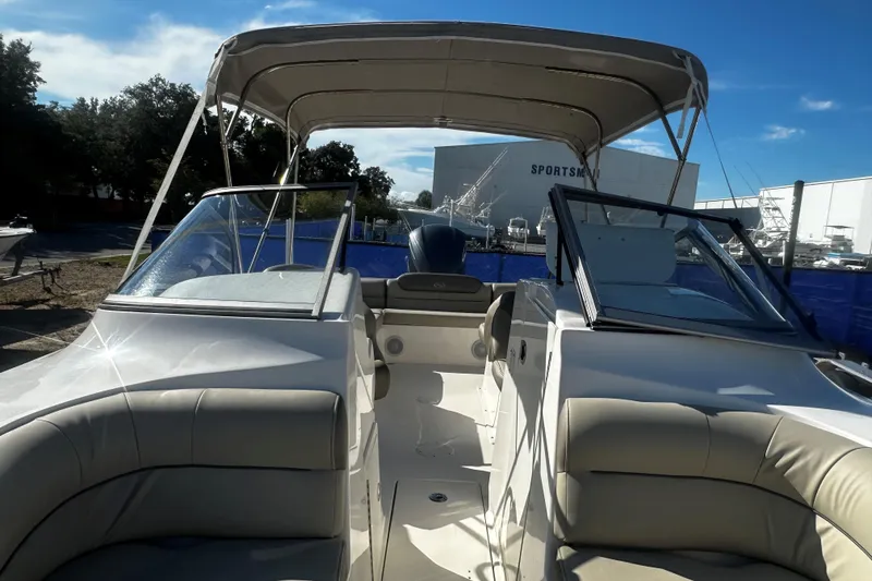 Slide: The Image of 2023 Key West 239 DFS boat interior with seating and canopy under clear sky. - 11
